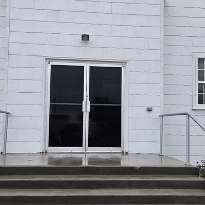 Outside picture of the full-length glass doors which replaced the original doors to our building in the 1970's