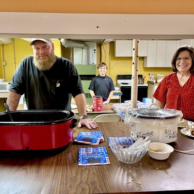 Board members David Spiker and Jo Ellen Whitehair serving food